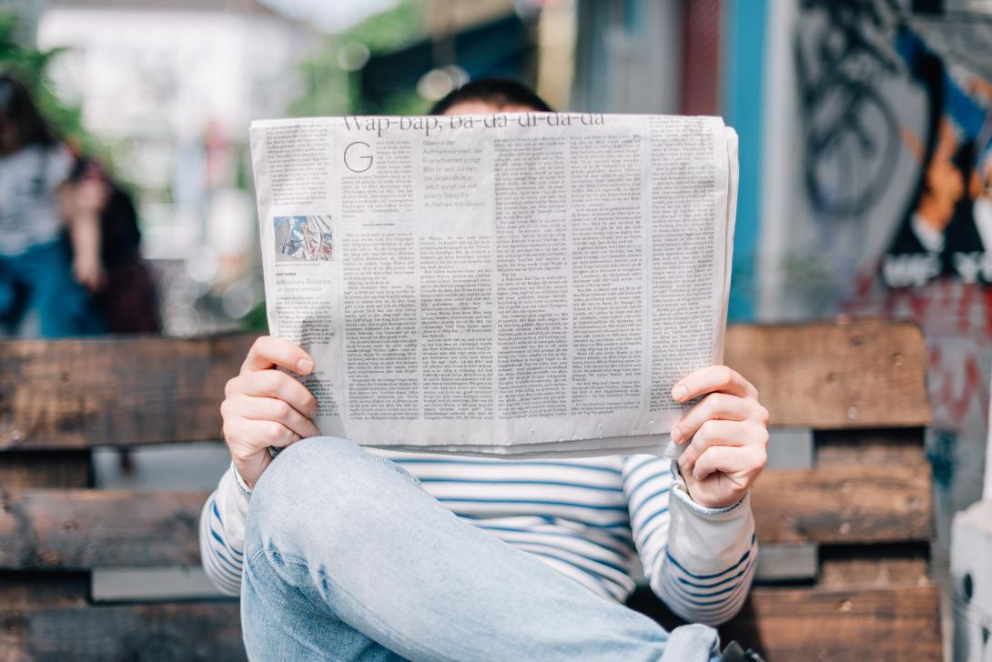 Person reading a newspaper