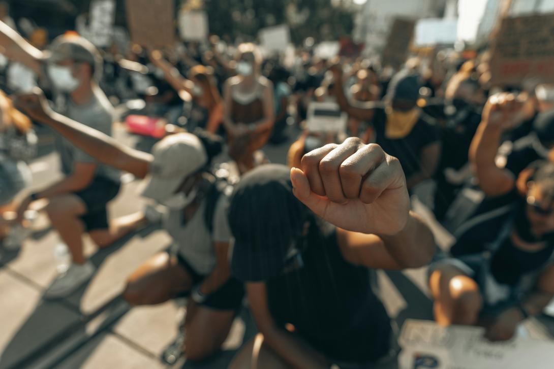 Kneeling protesters with fists in the air